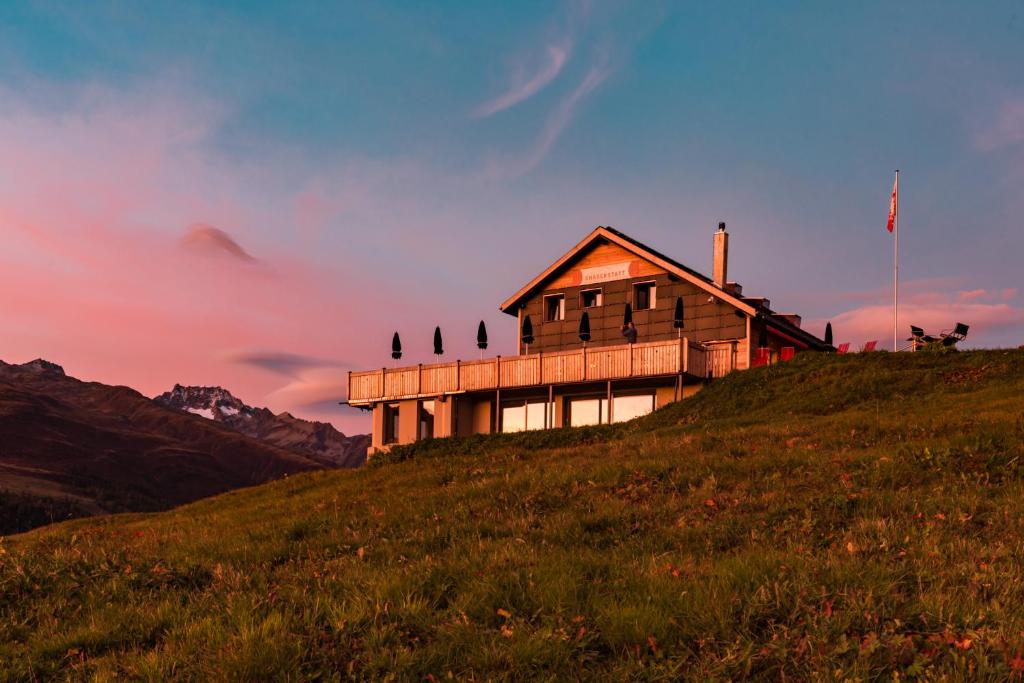 a house sitting on top of a hill at Berghotel Chäserstatt in Ernen