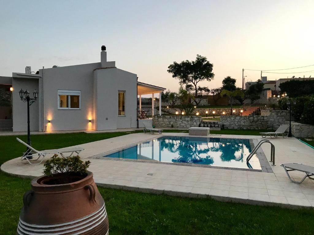 a house with a swimming pool in the yard at The Well in Chorafakia