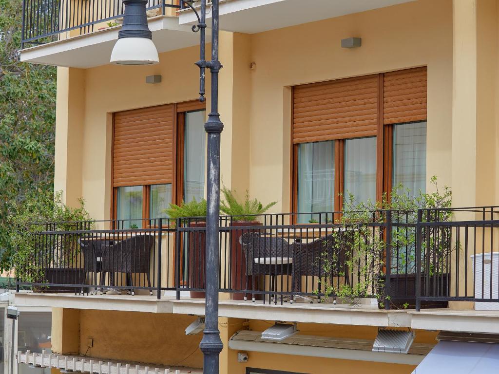a house with a balcony with chairs and a pole at Dea Guest House in Sorrento