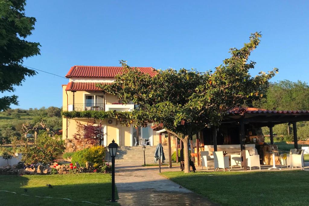 a house with a pavilion in front of it at Agnanti in Ávdhira