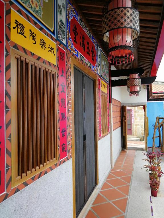 a building with signs on the side of it at Zhu Shan Grandee B&amp;B in Jincheng