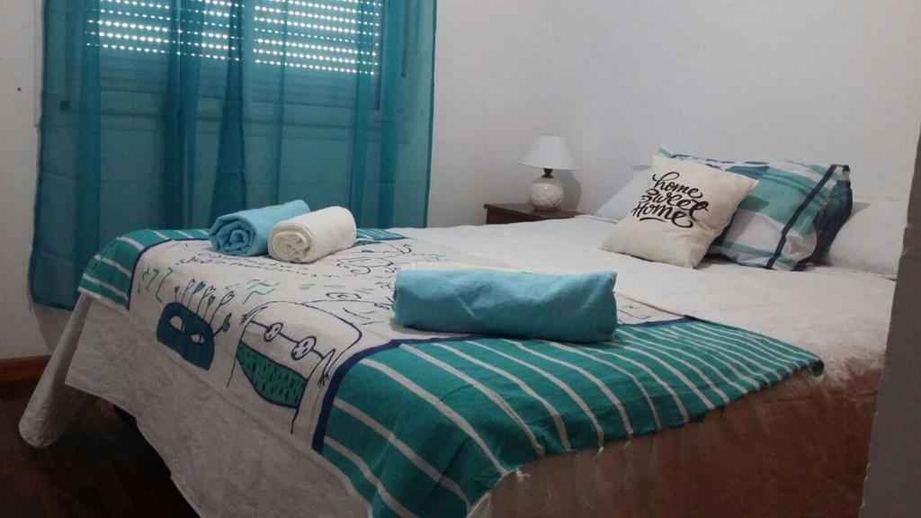 a bed with two pillows on top of it at Departamento de Celina in Olavarría