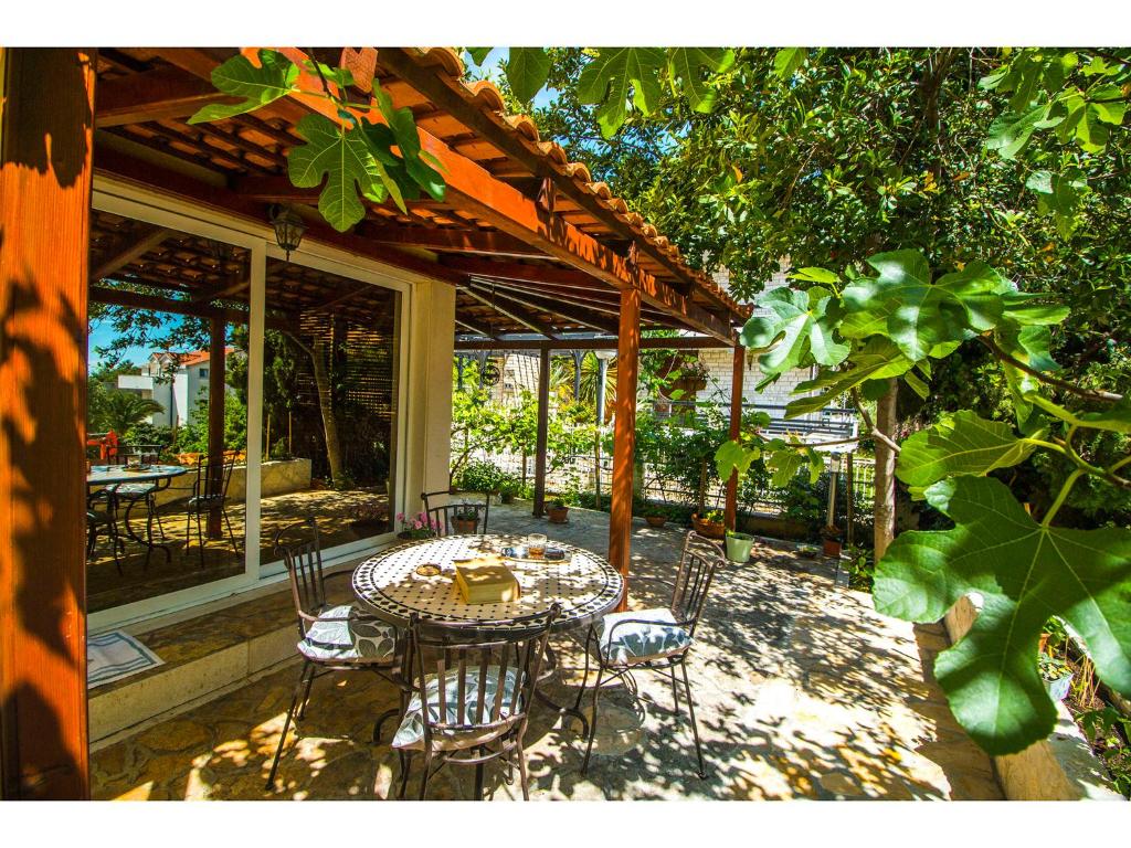 a patio with a table and chairs on a patio at Apartment Calypso in Split