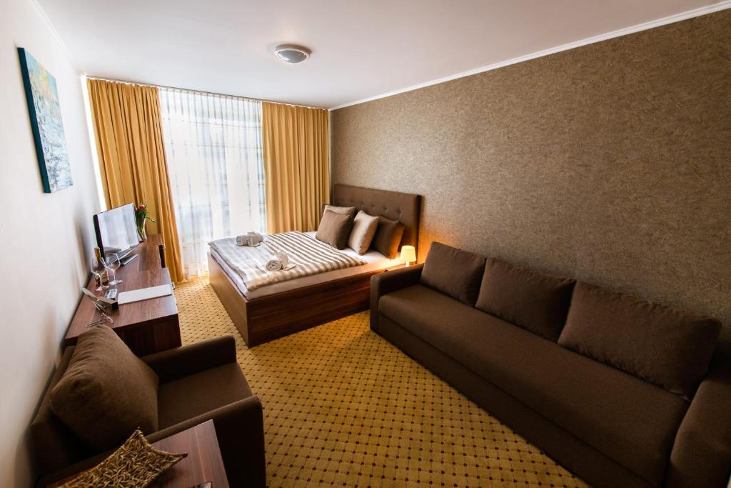 Postel nebo postele na pokoji v ubytování Hotel Merkur