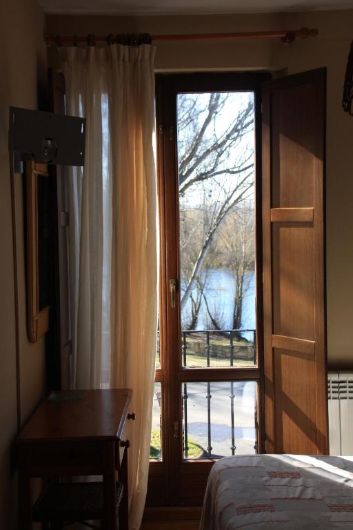 a bedroom with a sliding glass door with a view at Bardal de Huerta in Huerta