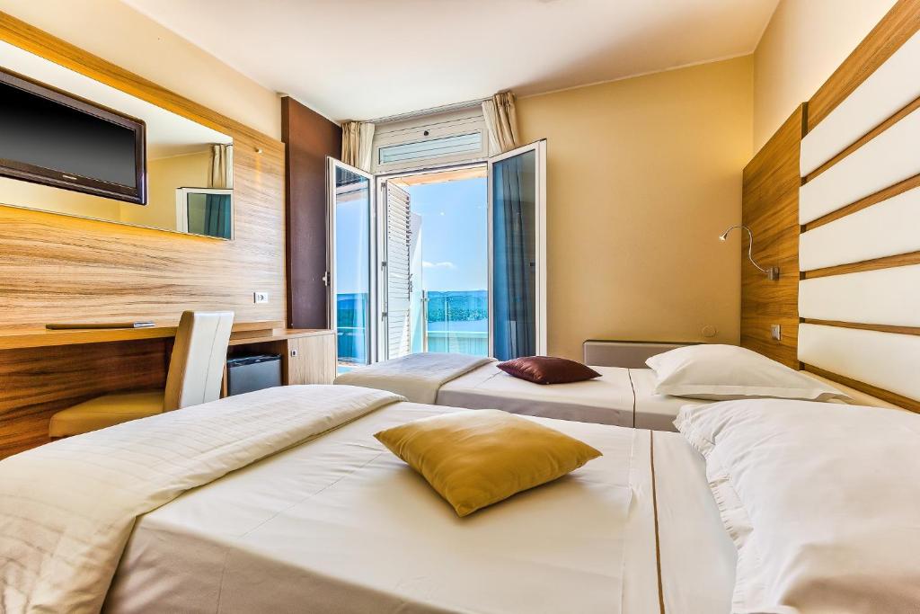 Postel nebo postele na pokoji v ubytování Hotel Panorama