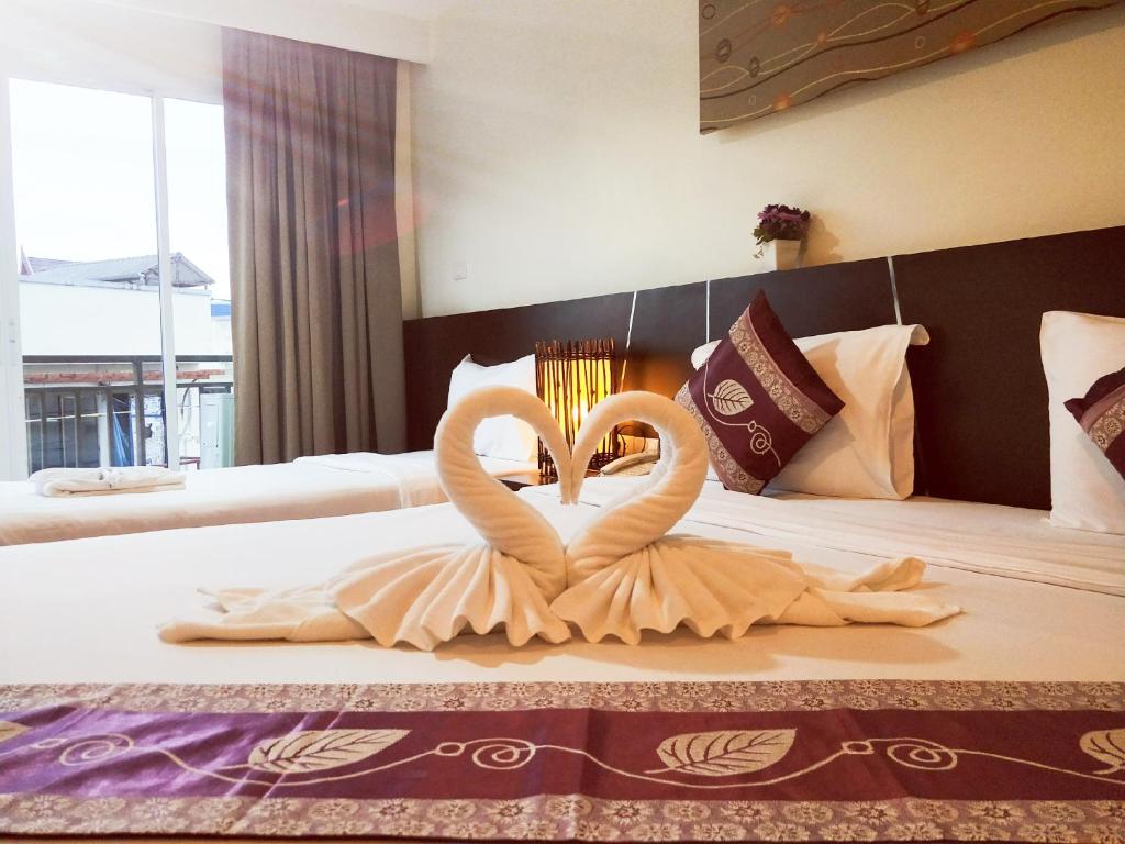 Postel nebo postele na pokoji v ubytování Pimrada Hotel