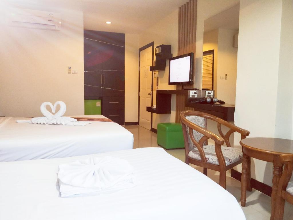 Postel nebo postele na pokoji v ubytování Pimrada Hotel