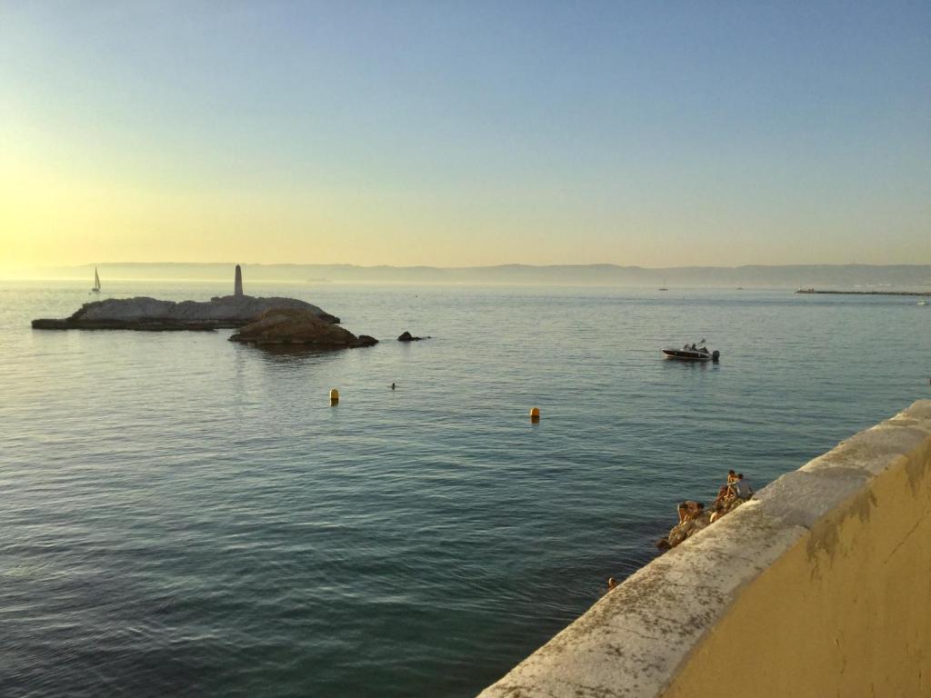 a view of a body of water with a lighthouse at Cabanon Marseillais 45 m2 sur l'eau à Malmousque in Marseille