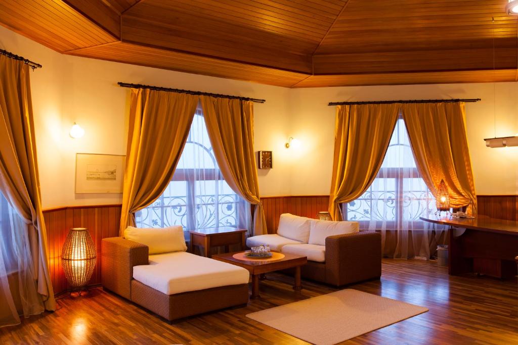 a living room with two couches and a piano at Complex Villas Kaliakra & Gradina in Bŭlgarevo