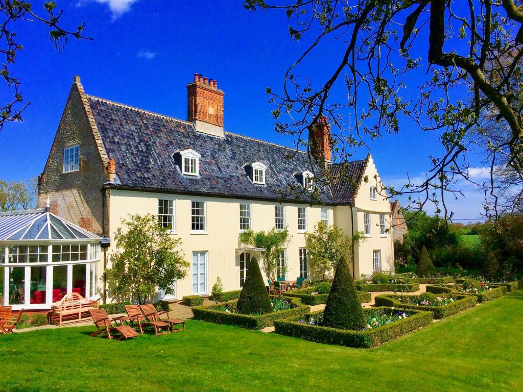 a large white house with a garden in front of it at Swafield Hall in Swafield