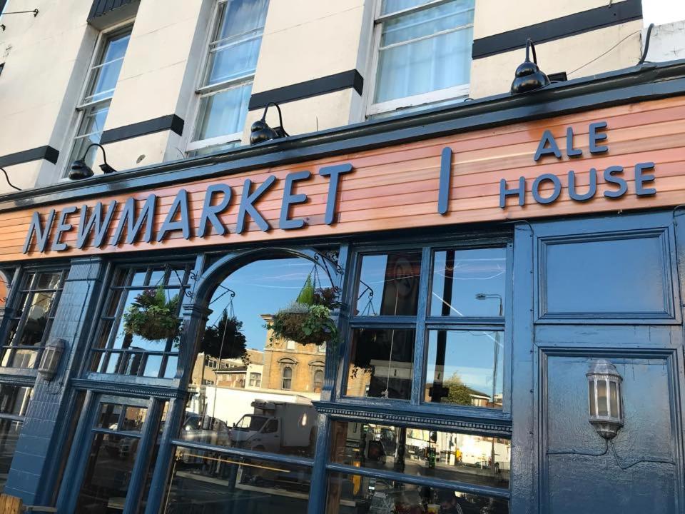 a building with a sign on the front of it at New Market Ale House in London