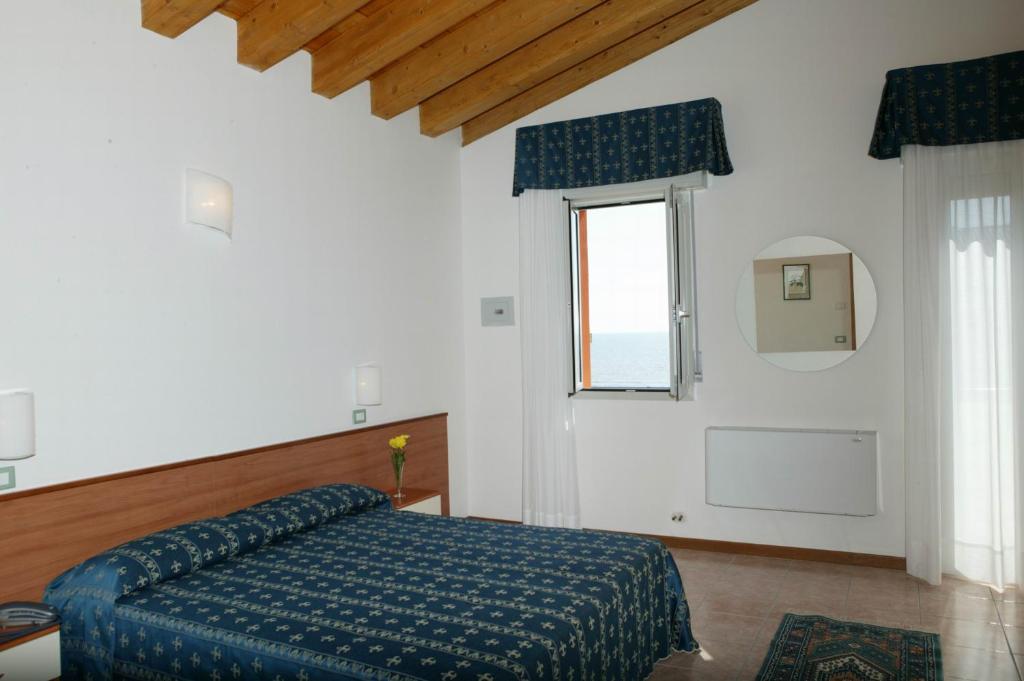 Postel nebo postele na pokoji v ubytování Hotel Ca' D'Oro