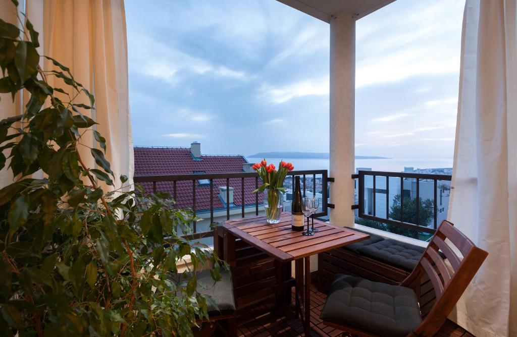 a balcony with a table and a view of the ocean at Andrea in Makarska