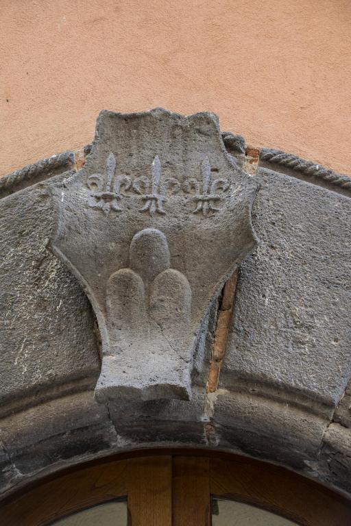 a sculpture of a hand on the side of a building at B&B Le Buche Casa Storica in Canino