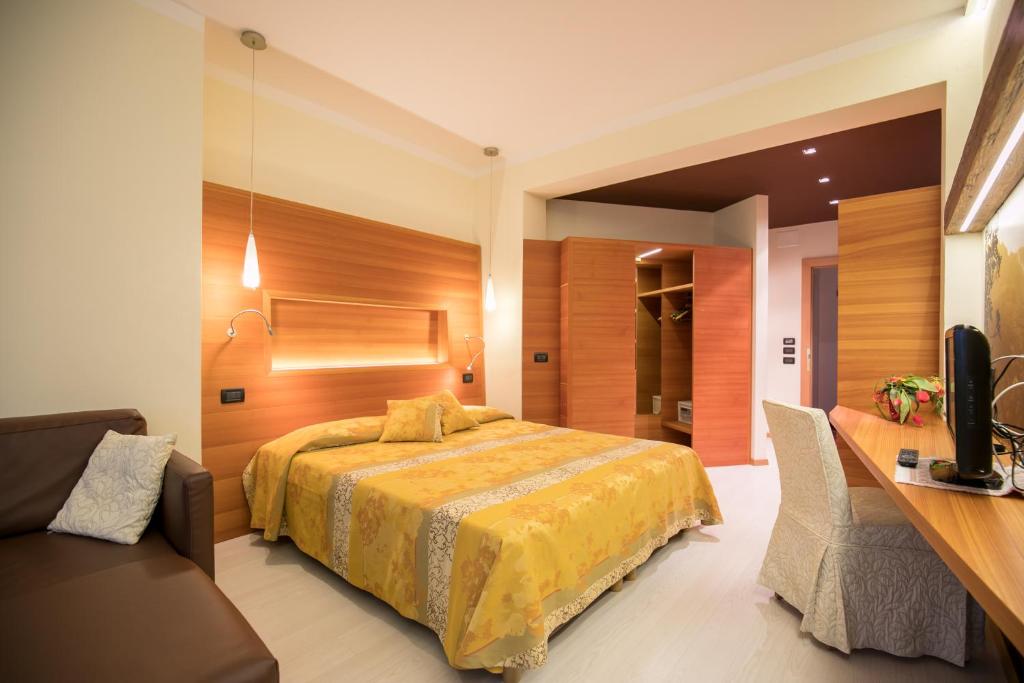 Postel nebo postele na pokoji v ubytování Hotel Daniela