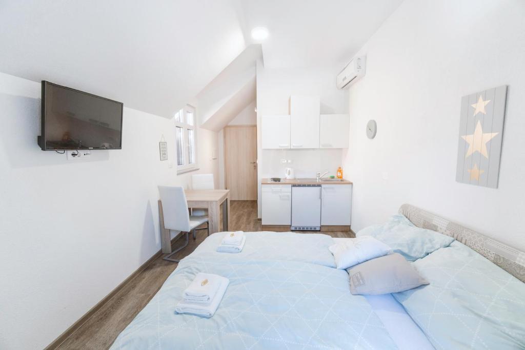 a bedroom with a large blue bed in a room at Anita's Studio Apartments in Ljubljana