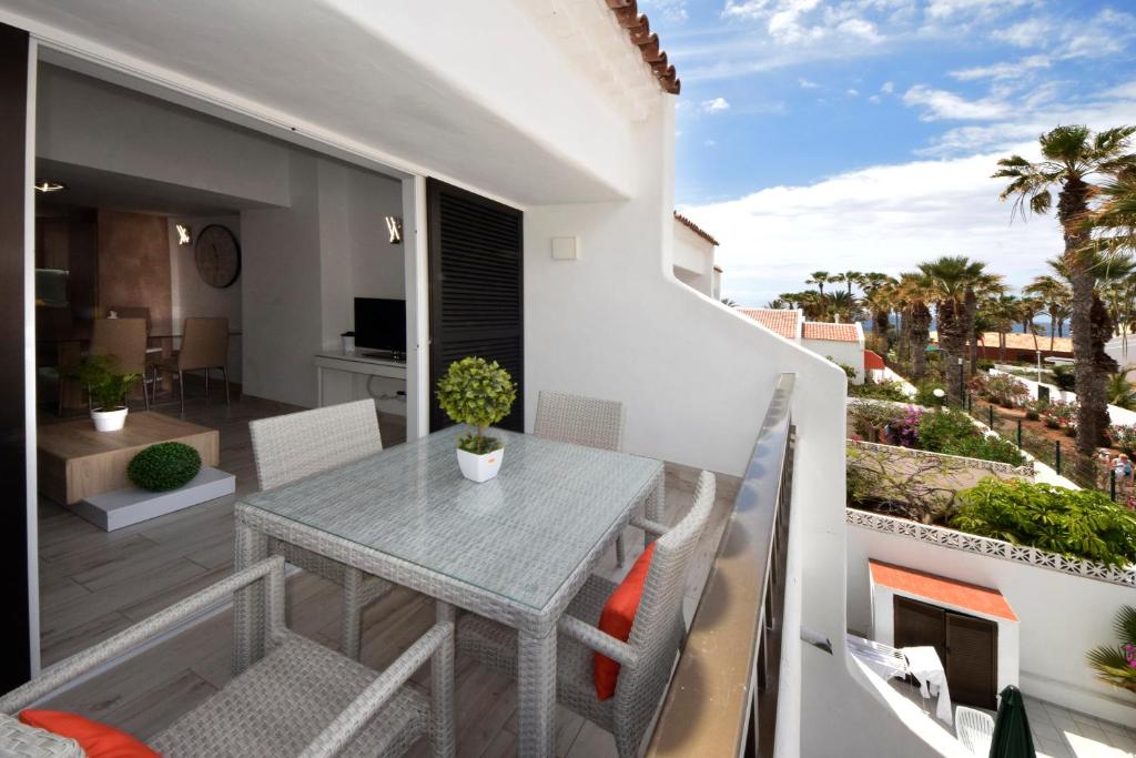 a balcony with a table and chairs on a patio at Parque Santiago Luxury 306 in Arona