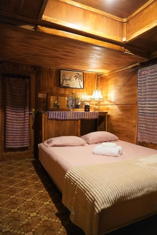 Postel nebo postele na pokoji v ubytování Satu Lingkung