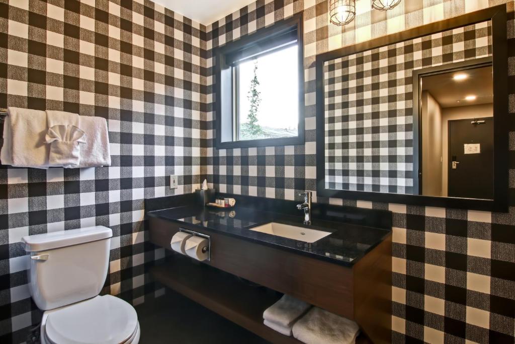 a bathroom with a sink and a toilet at Canalta Lodge in Banff