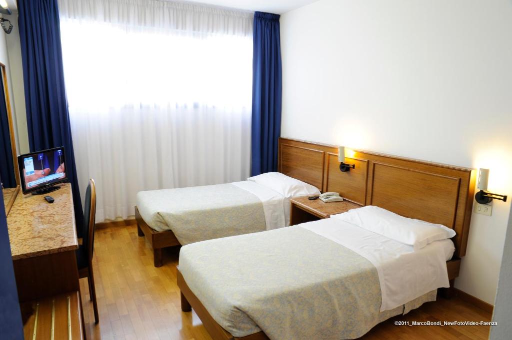 Postel nebo postele na pokoji v ubytování Hotel Cavallino