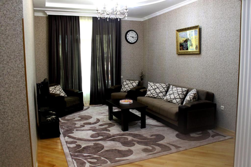 a living room with a couch and a table at Green Guest House in Kutaisi