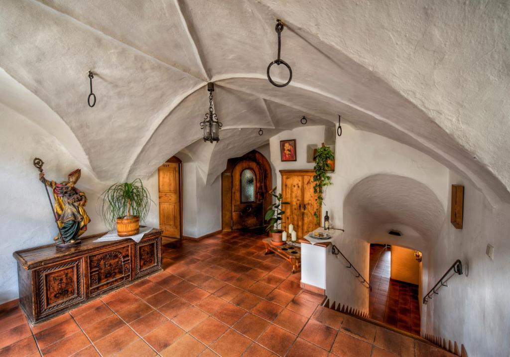 a large room with an arched ceiling and a wooden table at Bärenwirth in Innsbruck