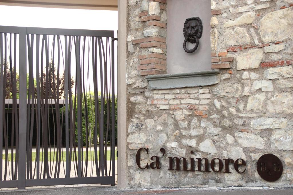 a door to a stone building with a gate at B&B a Ca' Minore Franciacorta in Passirano