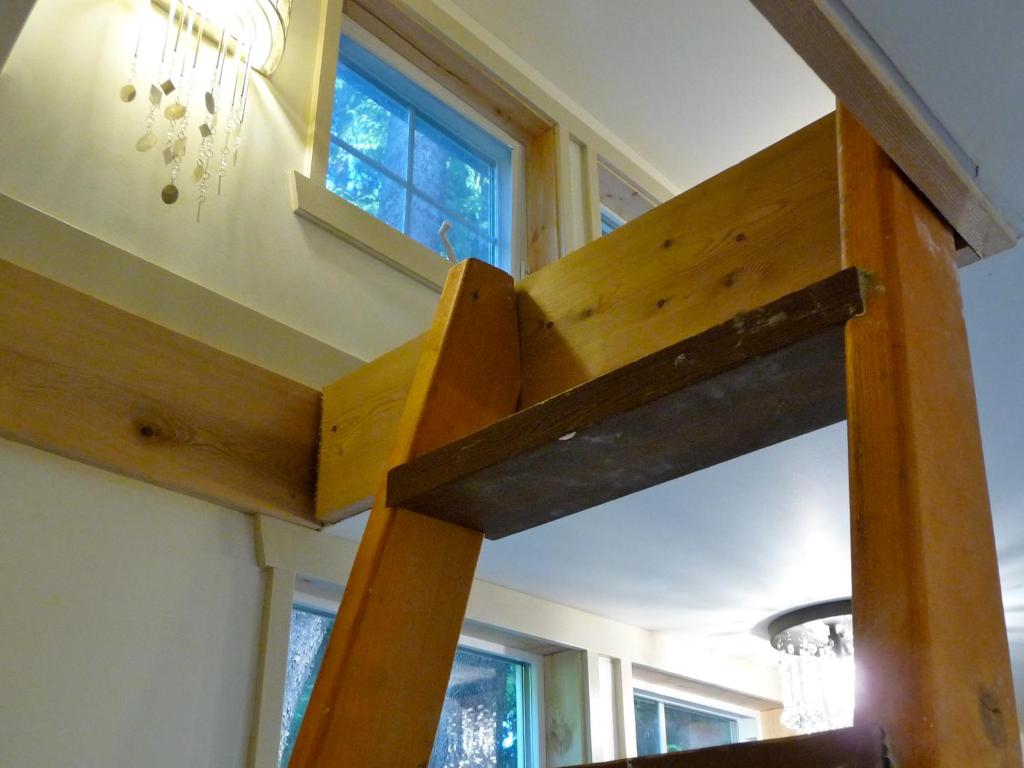 a wooden bench in a room with a window at Magnolia Petal in Ganges