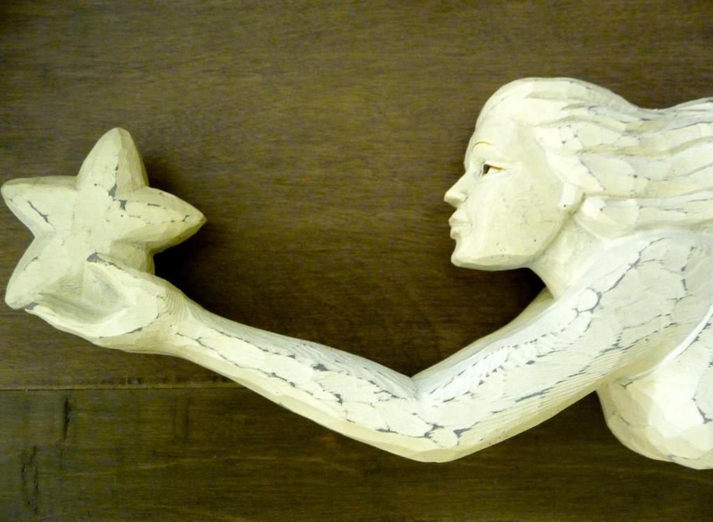 a statue of a woman holding a star at Magnolia Petal in Ganges
