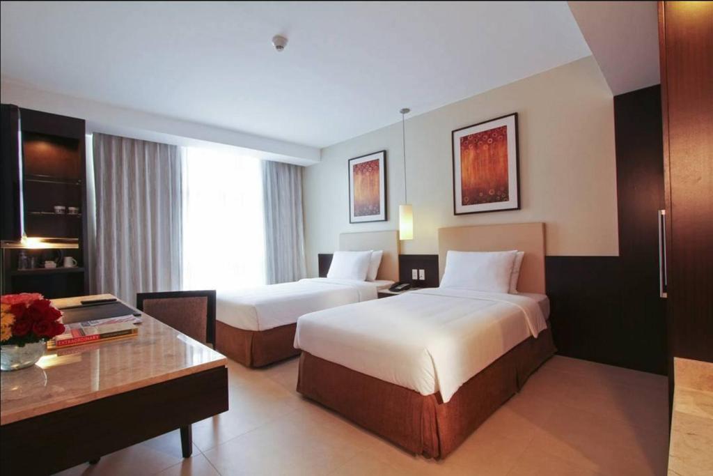 Letto o letti in una camera di The B Hotel Alabang