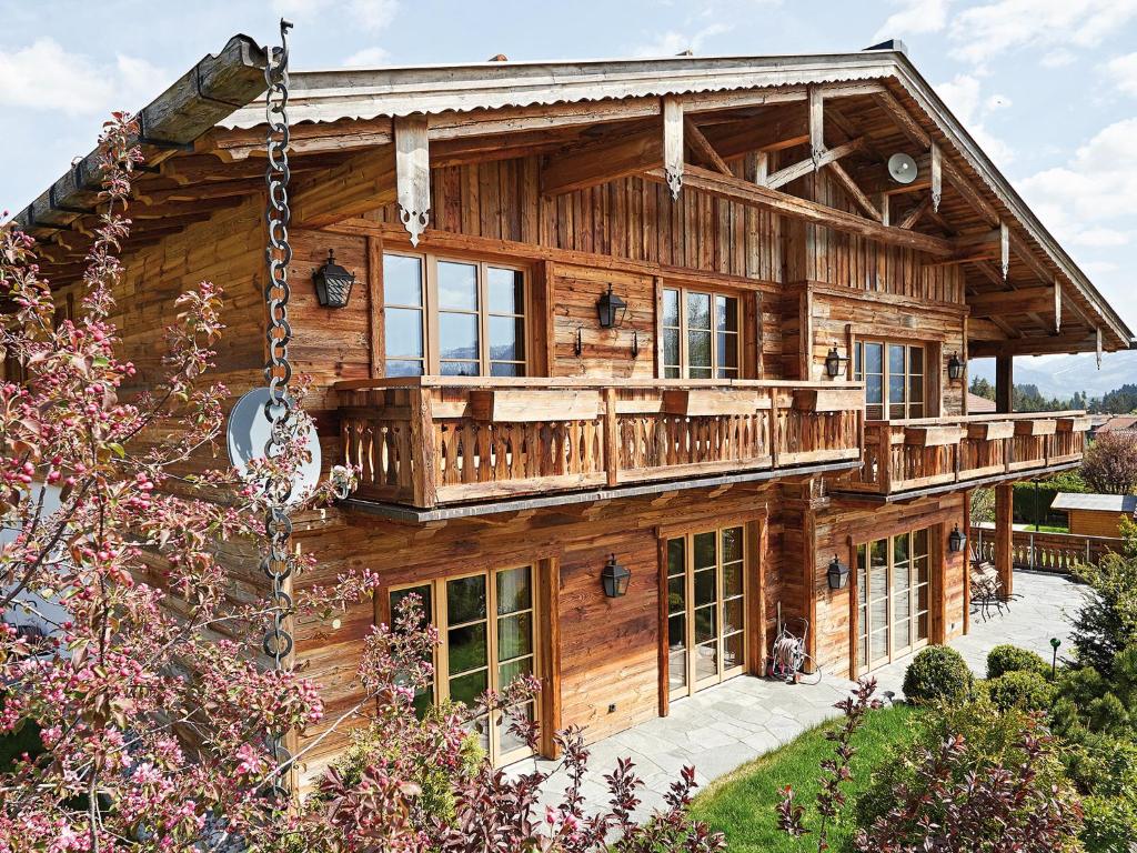 a log cabin with a wrap around deck at Chalet-F in Ofterschwang