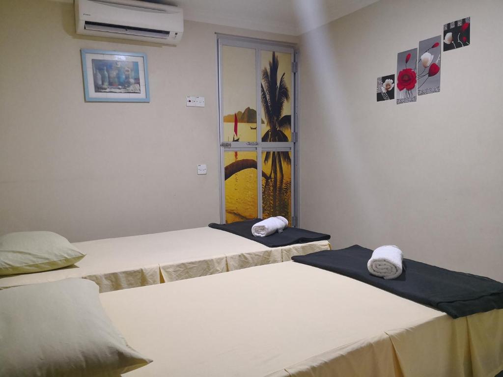 Postel nebo postele na pokoji v ubytování Kristal Inn Hotel UITM Shah Alam