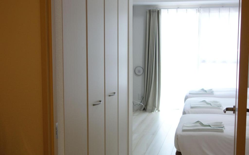Postel nebo postele na pokoji v ubytování Bay Hotel Urayasu-ekimae