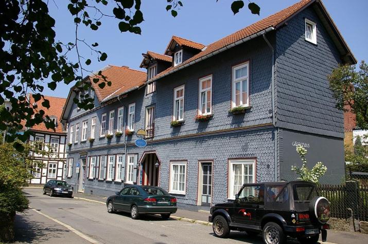 a black truck parked in front of a blue building at Gästehaus Schmitz in Goslar