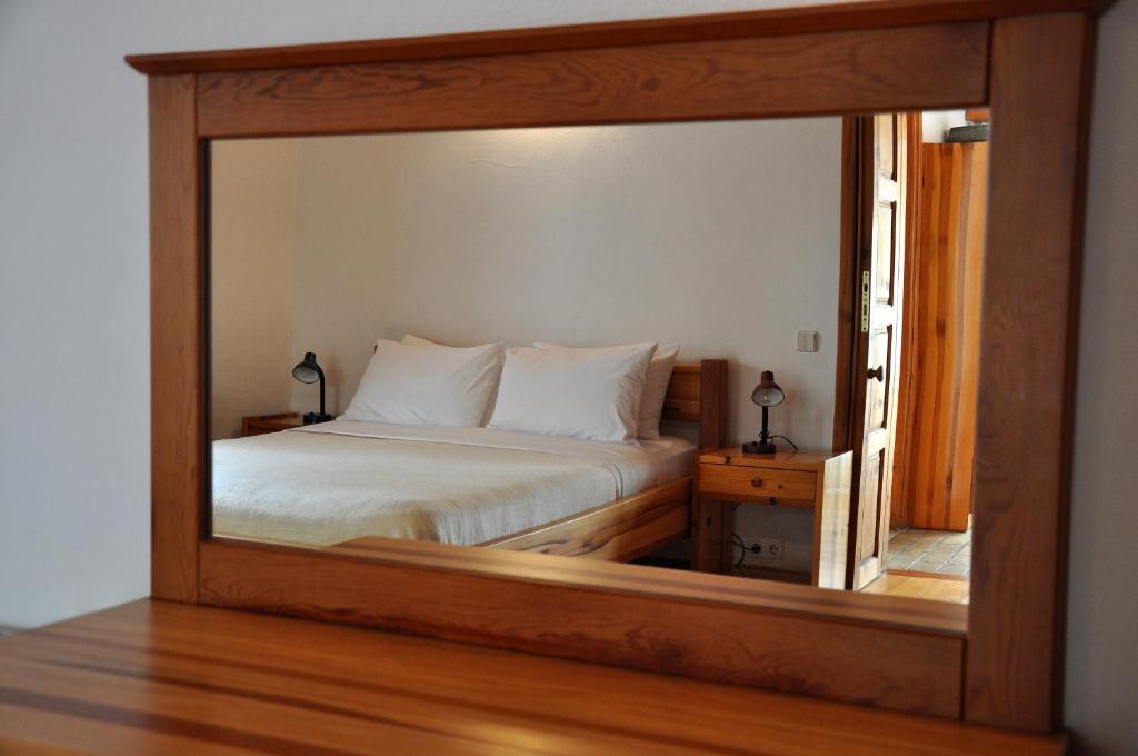 a mirror reflection of a bed in a bedroom at Garden House in Selçuk