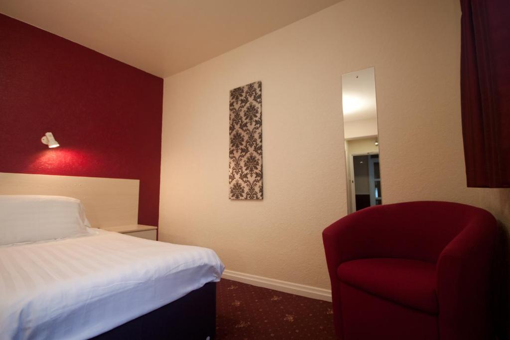 Postel nebo postele na pokoji v ubytování Norfolk Hotel