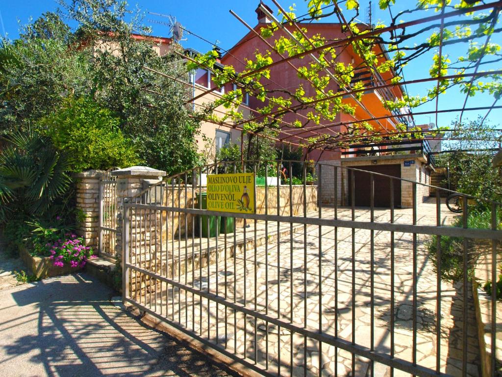 a fence with a sign in front of a house at Apartment Marino 1619 in Banjole