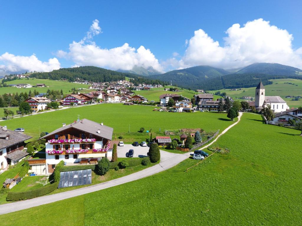 an aerial view of a small village in a green field at Residence Condor in Maranza