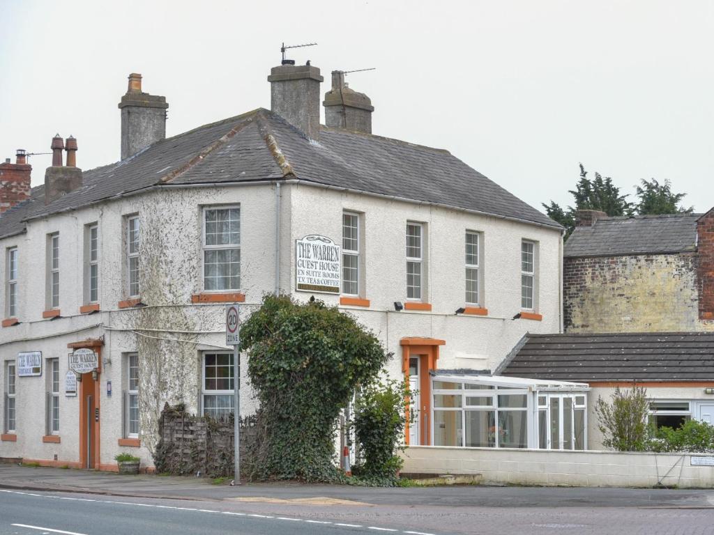 a large white building on the side of a street at The Warren Guest House in Carlisle