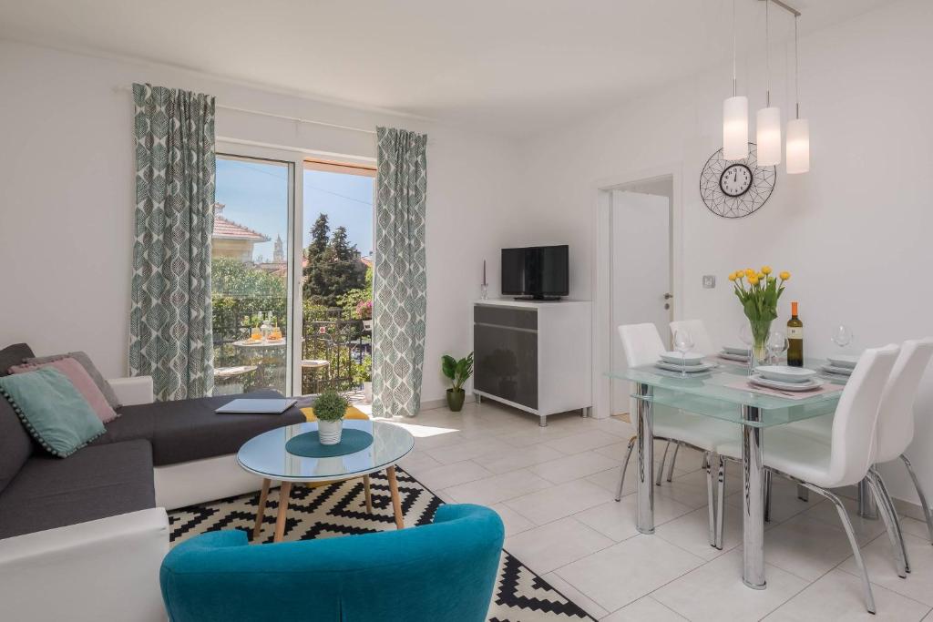 a living room with a couch and a table at Apartments CenterLink in Split