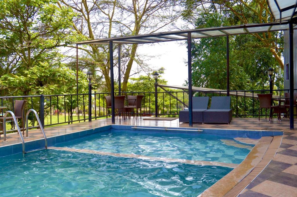 a swimming pool with a pergola next to a patio at Park Place Hotel in Nairobi