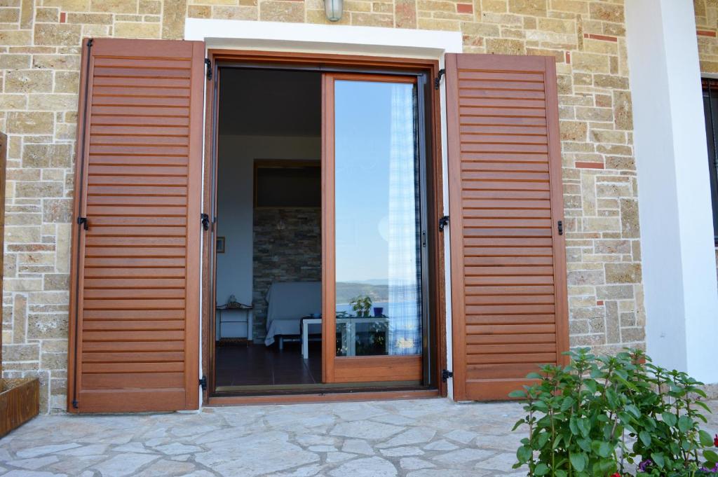 a sliding glass door with a view of the ocean at Marvelous Sea View Eco Apt in Ammouliani