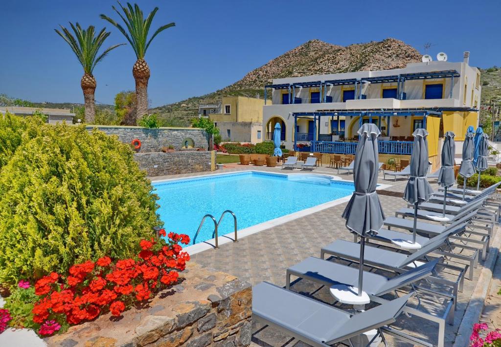 a villa with a swimming pool and a resort at Emporios Bay Hotel in Emporeios