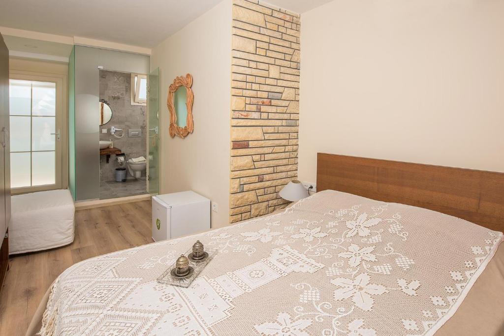 a bedroom with a bed with a blanket on it at Destina Hotel in Çeşme