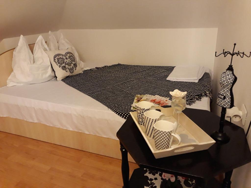 a bedroom with a bed and a table with a tray at Vila Calix in Băile Govora