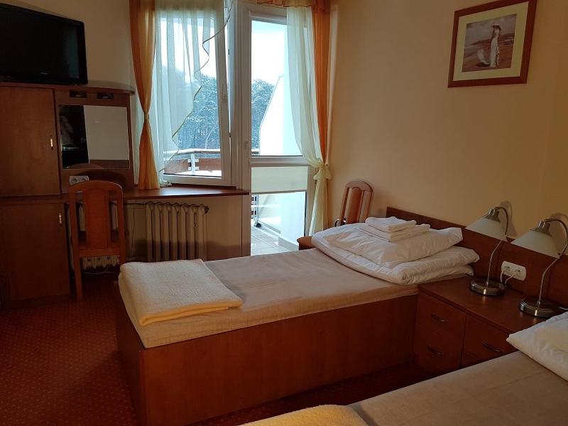 Postel nebo postele na pokoji v ubytování Hotel Ustka