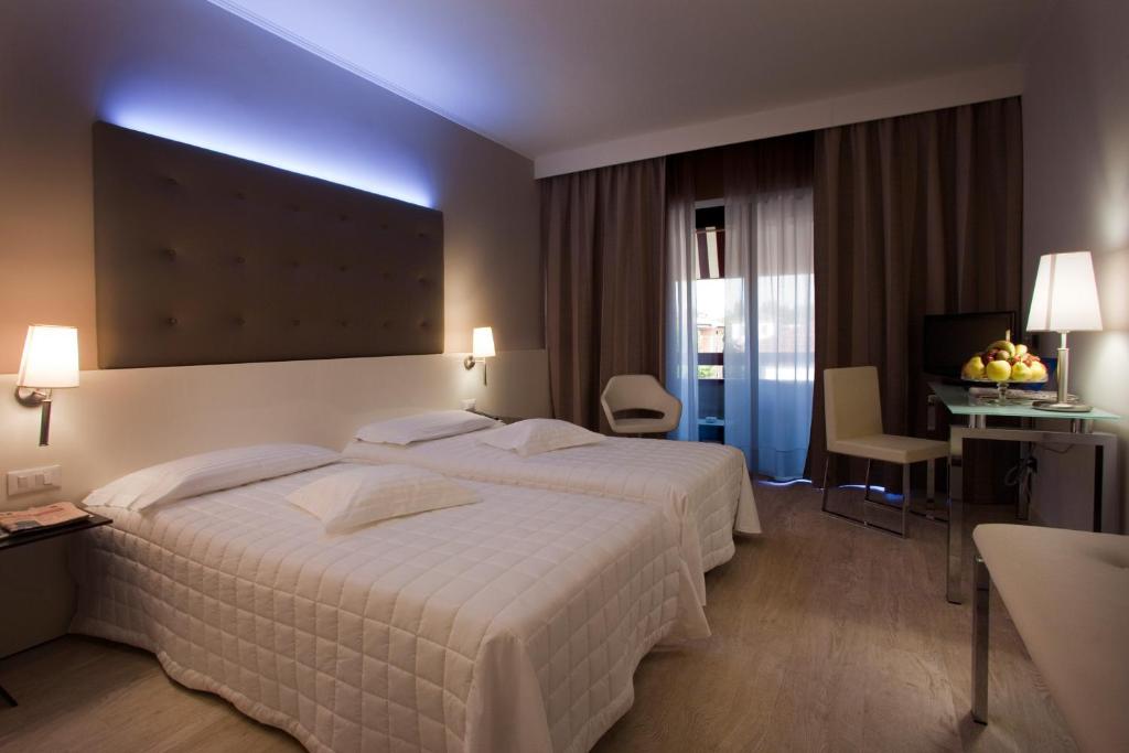 Postel nebo postele na pokoji v ubytování Hotel Desenzano