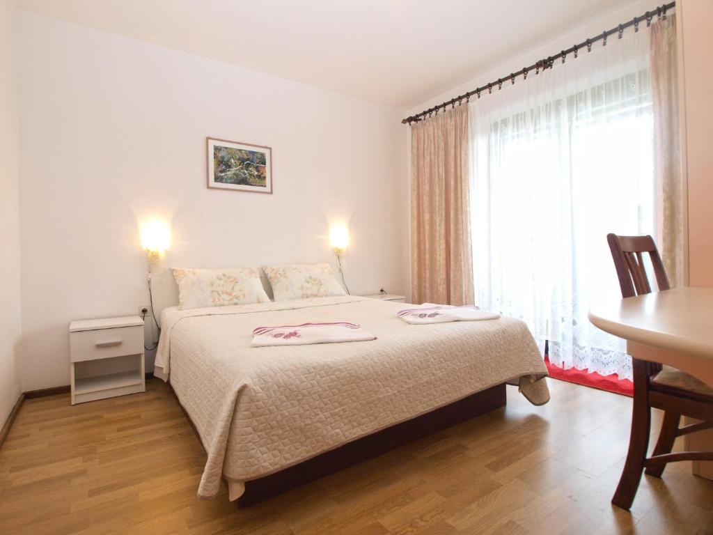 Postel nebo postele na pokoji v ubytování Apartments Dragana 1508