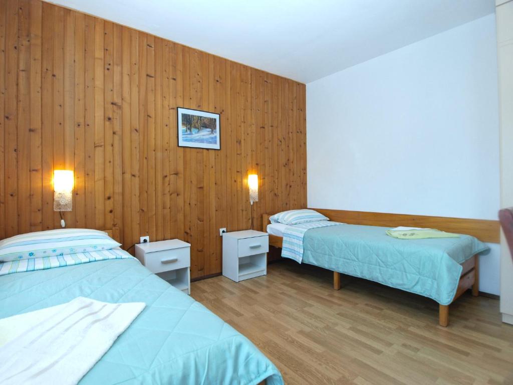 Postel nebo postele na pokoji v ubytování Apartments Dragana 1508